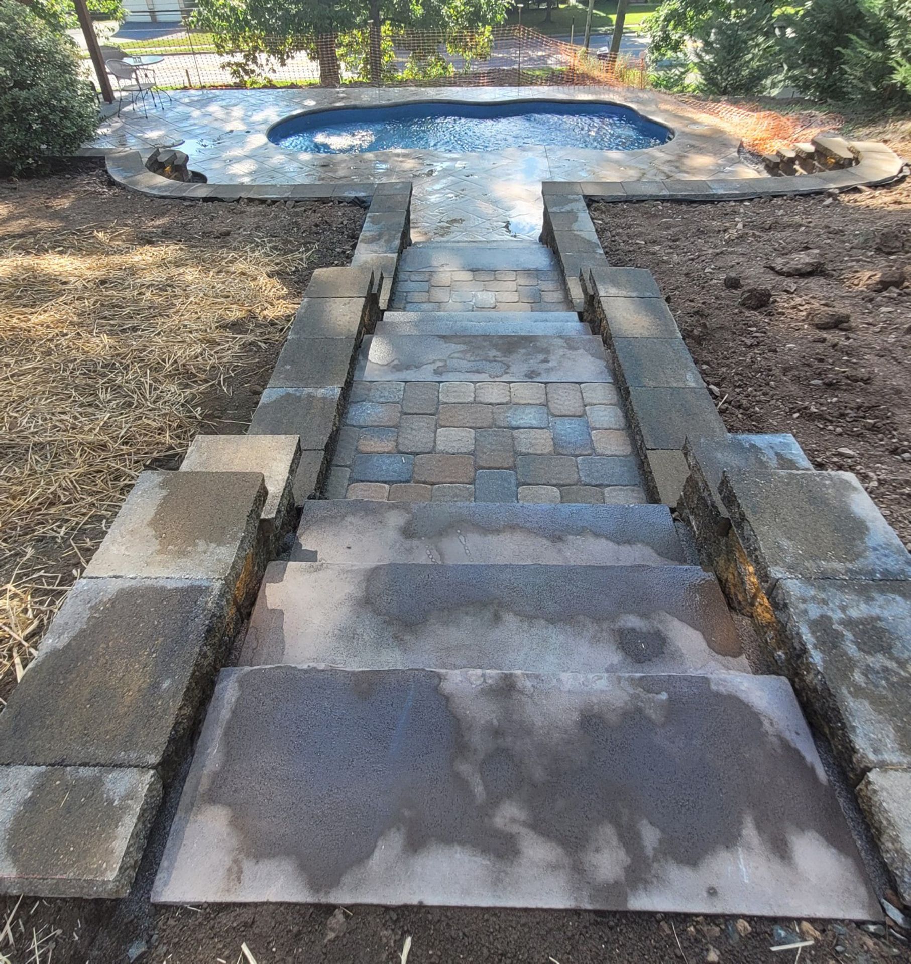 A set of stairs leading up to a swimming pool