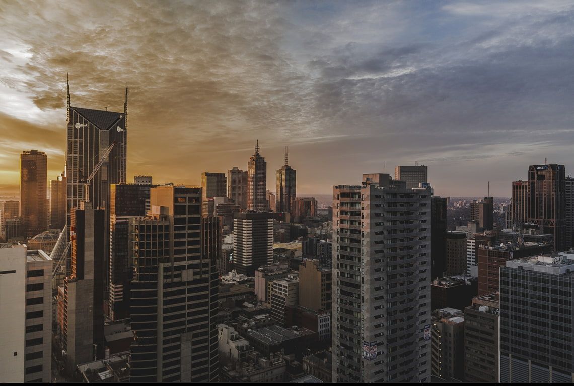 An aerial view of a city skyline at sunset.