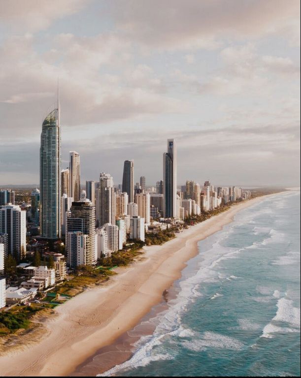 An aerial view of a city skyline with a beach in the foreground.