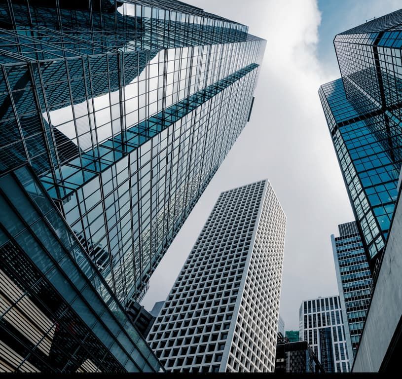 Looking up at a city skyline with lots of tall buildings