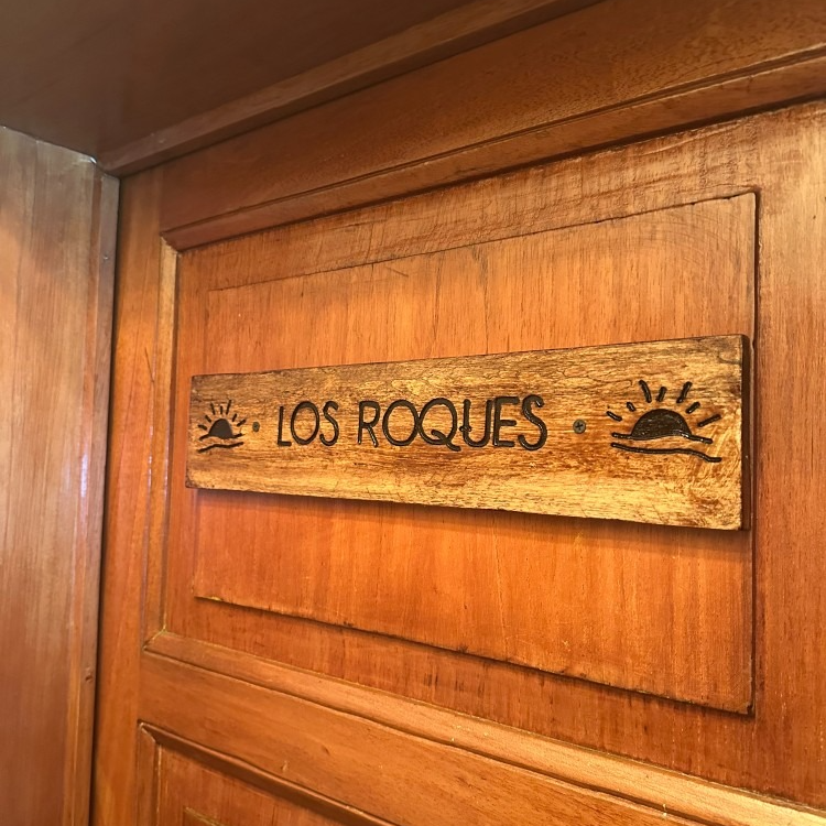 Wooden plaque on a wooden door reads