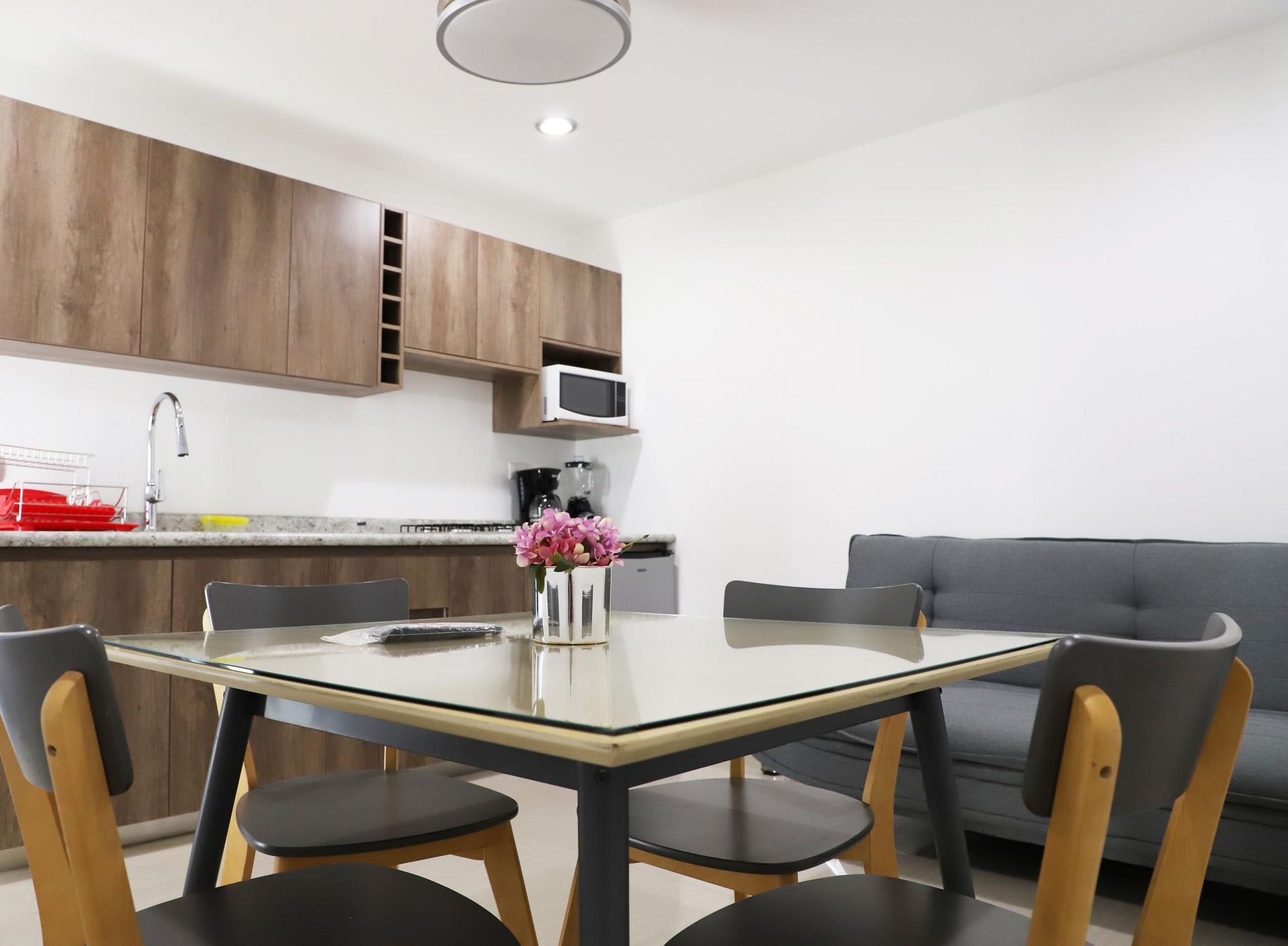 Una sala de estar con una mesa de comedor y sillas y un sofá.