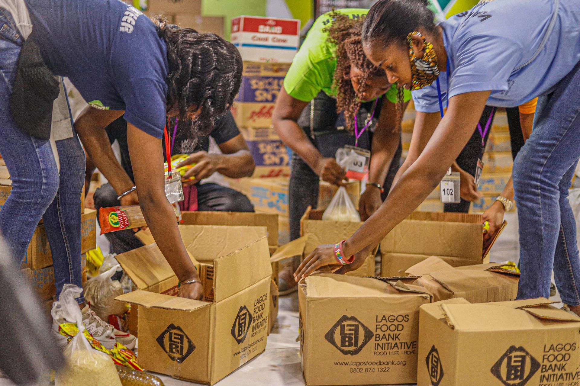 People packing food into boxes at a Lagos Food Bank.