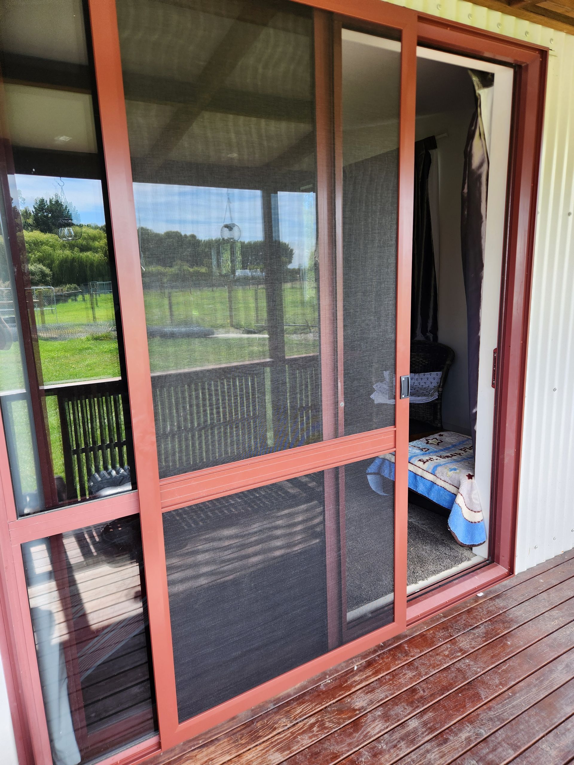 A large sliding glass door with a wooden frame