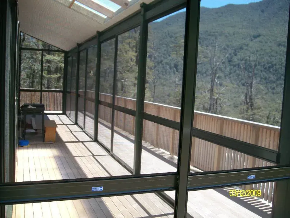 A screened in porch with a view of the mountains
