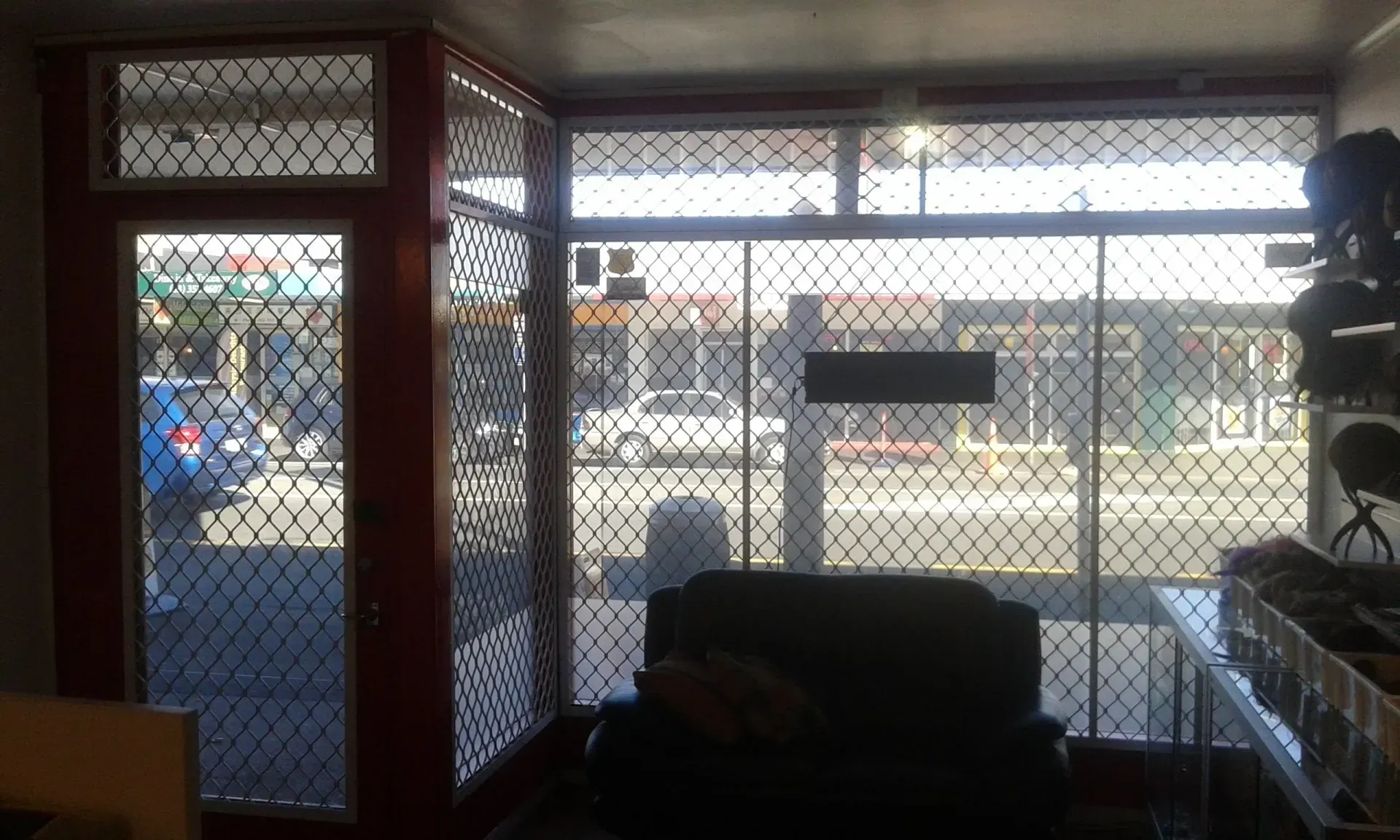 A room with a lot of windows and a chair in it