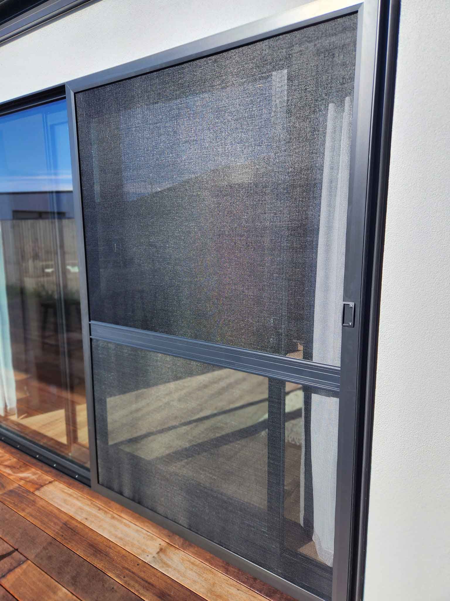 A sliding glass door with a screen on it.