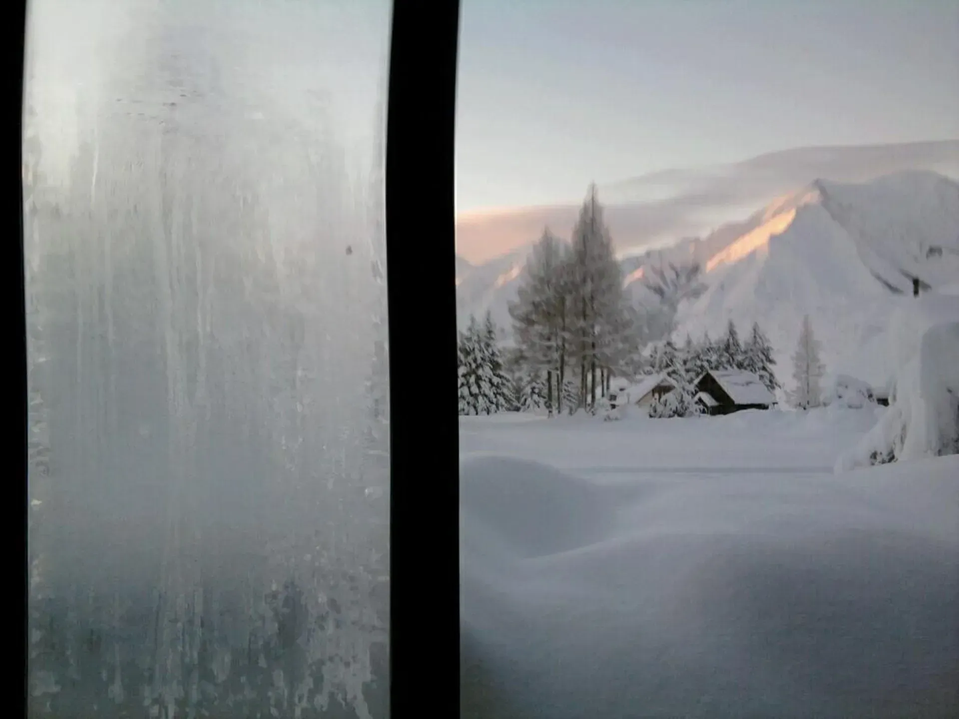 A window with a view of a snowy landscape and a window with a view of a snowy landscape.