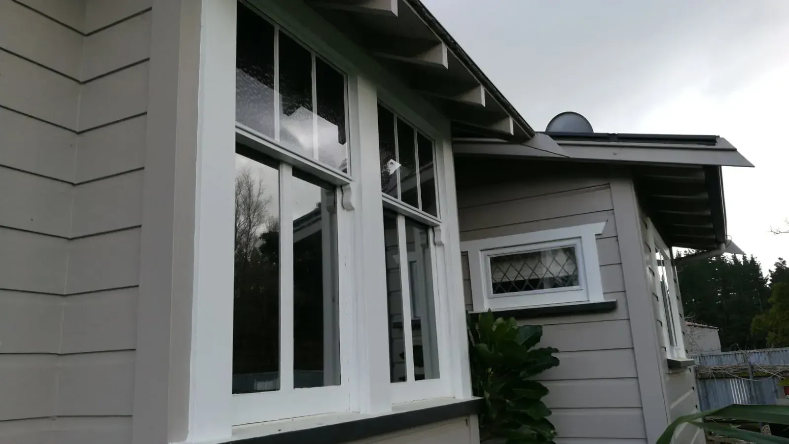 A white house with a large window on the side