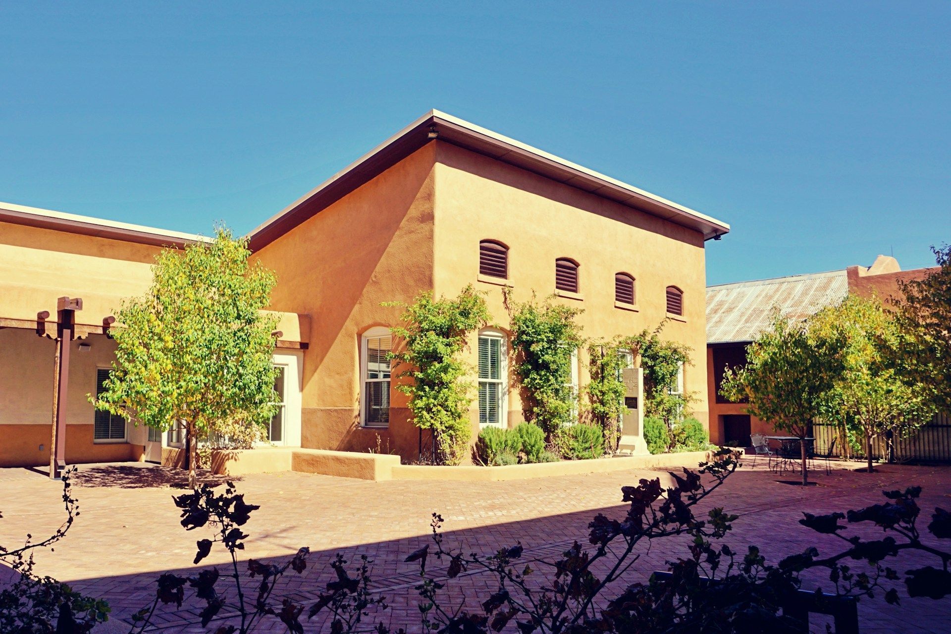 A large building with arches and a fountain in front of it