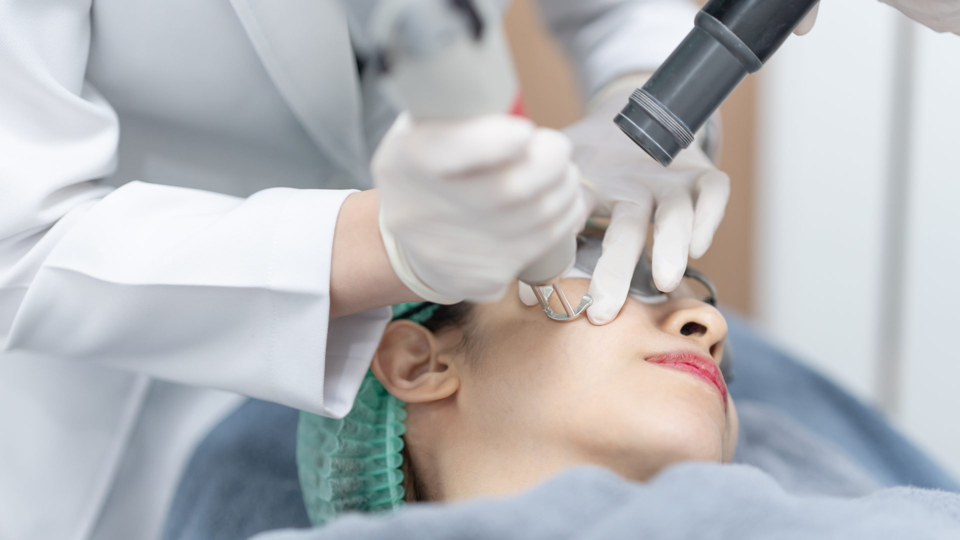 Dental procedure with clinician using tools on patient’s face in a bright clinic