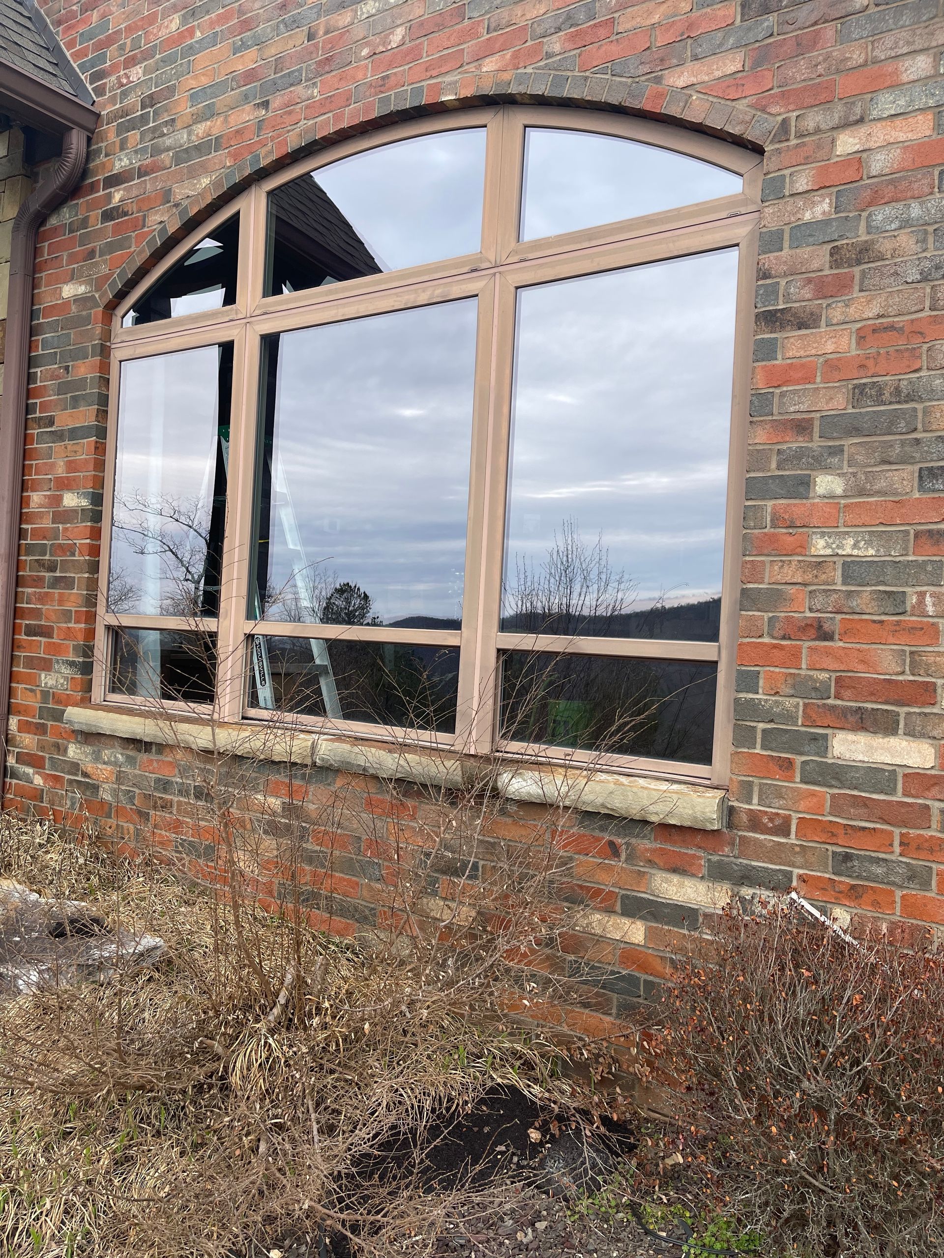 A large window on the side of a brick building.