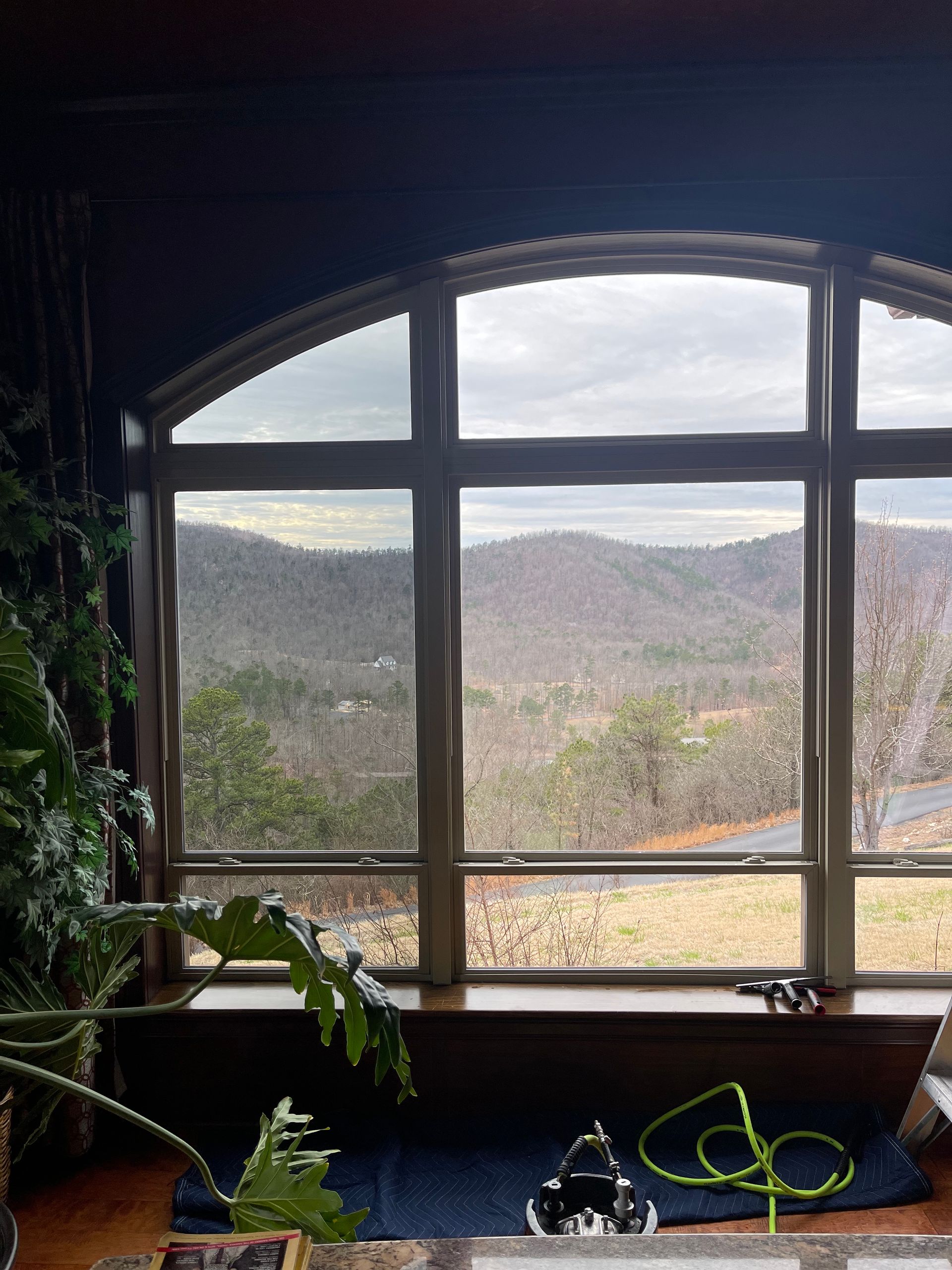 A large window with a view of a mountain range