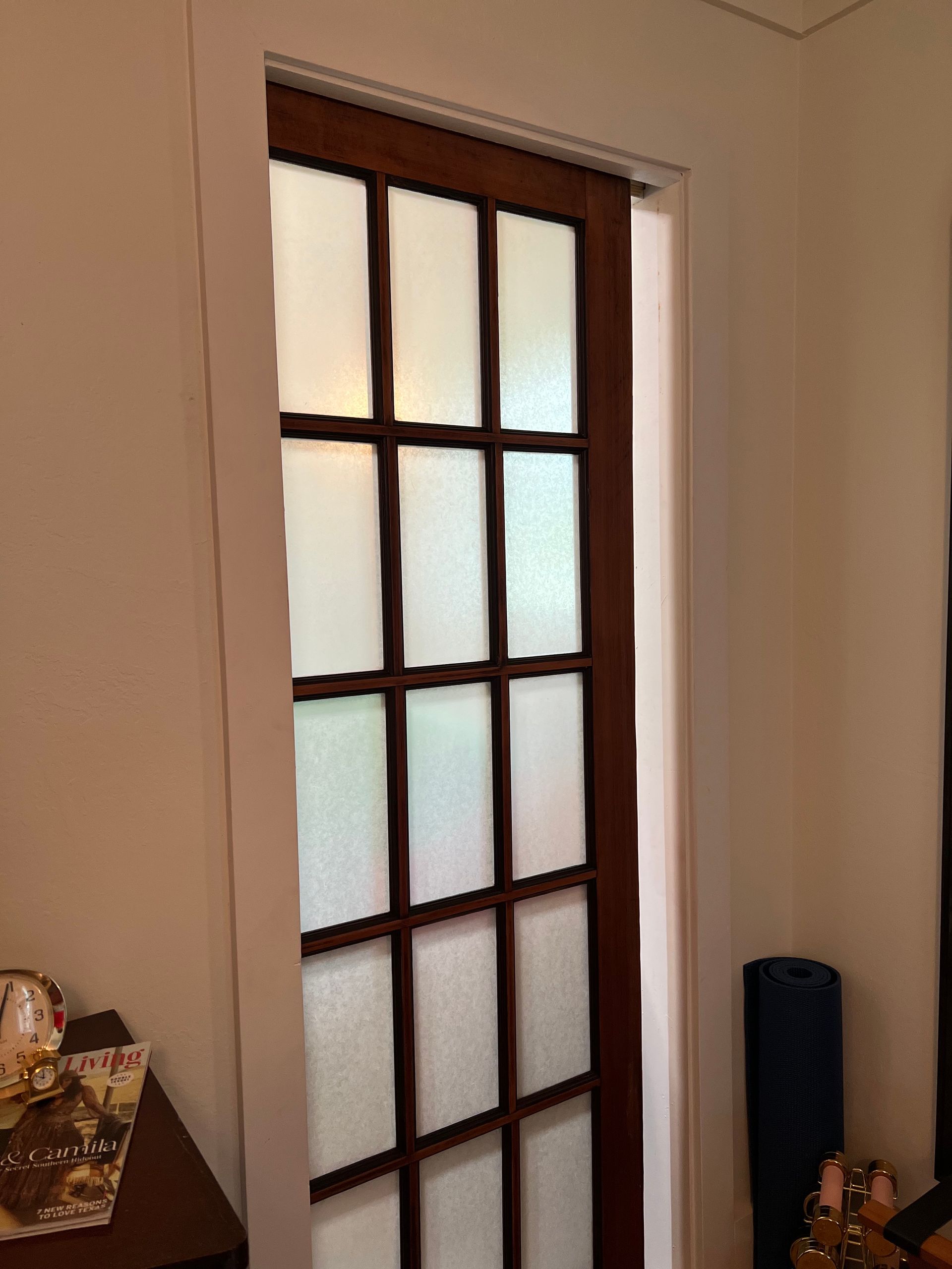 A sliding glass door is open in a room