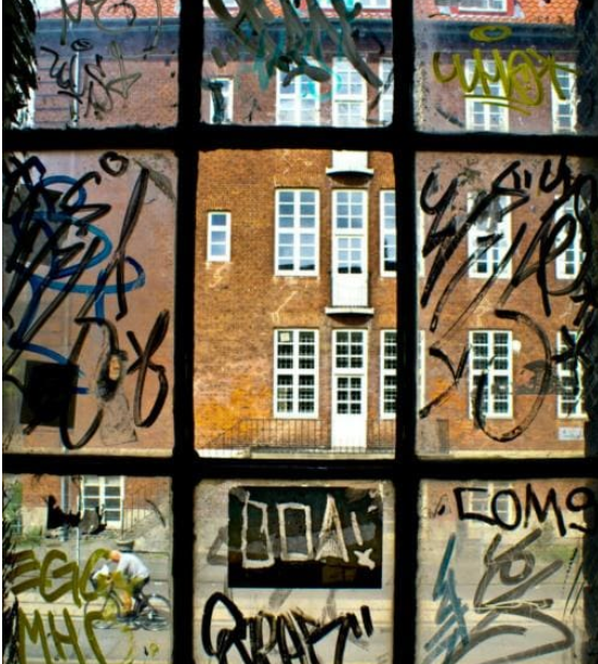 A window with graffiti on it including the word boay