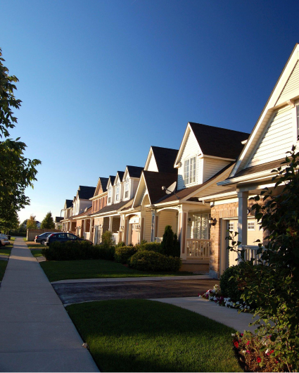 A row of houses with a blue sky in the background