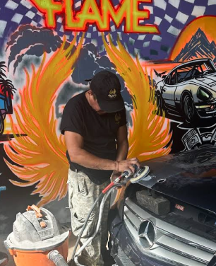 Technician focused on detailing of vehicle | Flame Auto Repair