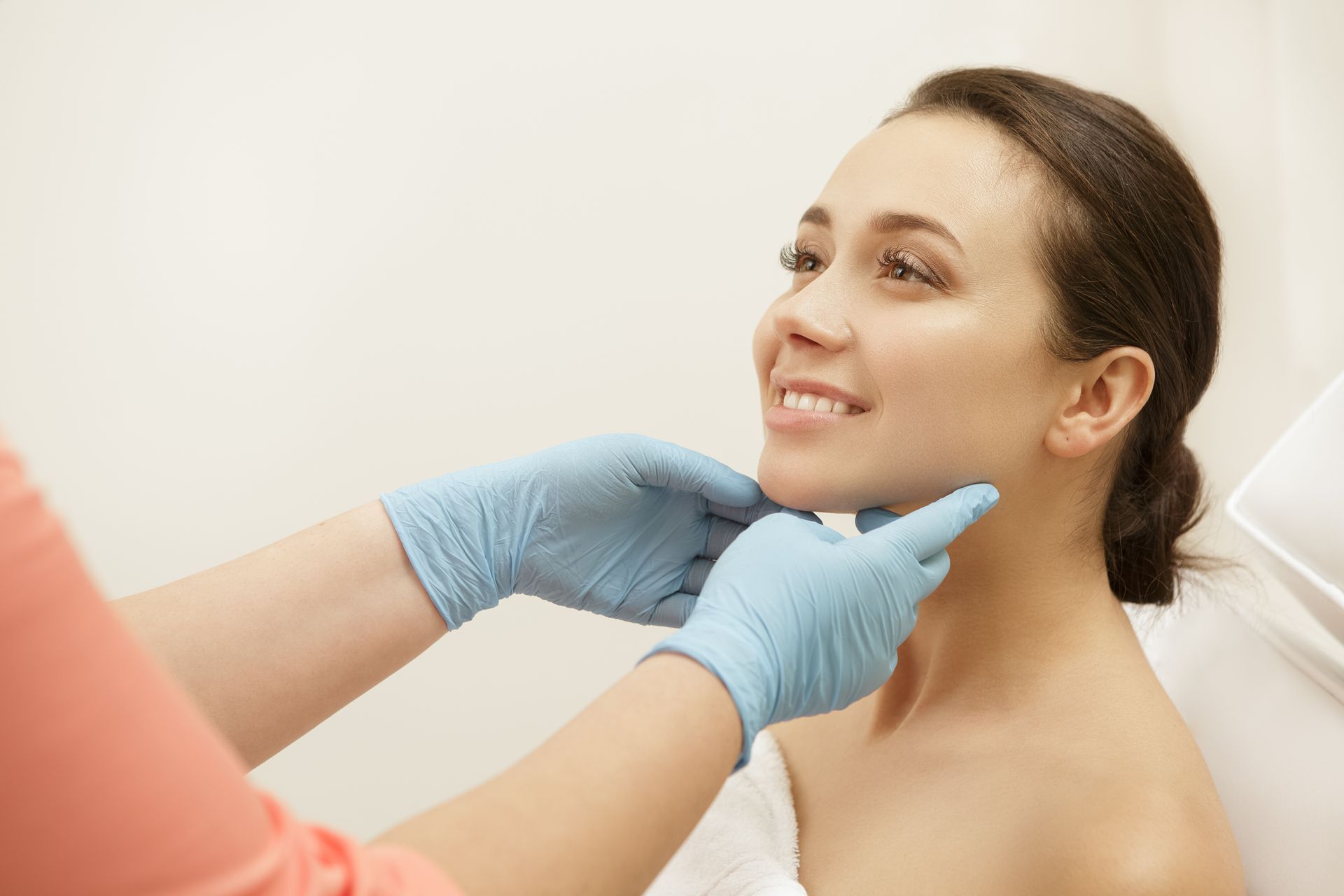 A woman is getting her neck examined by a doctor.