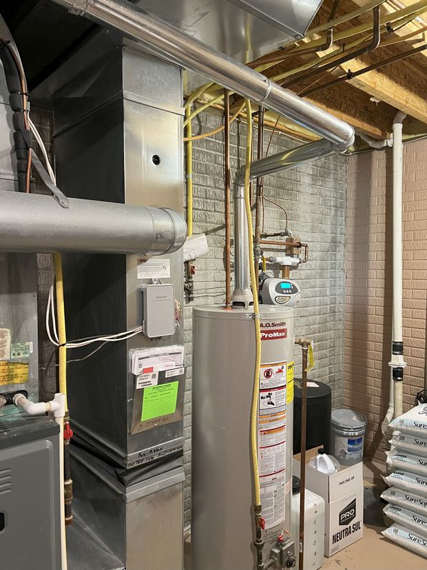 A room with a lot of pipes and appliances in it.