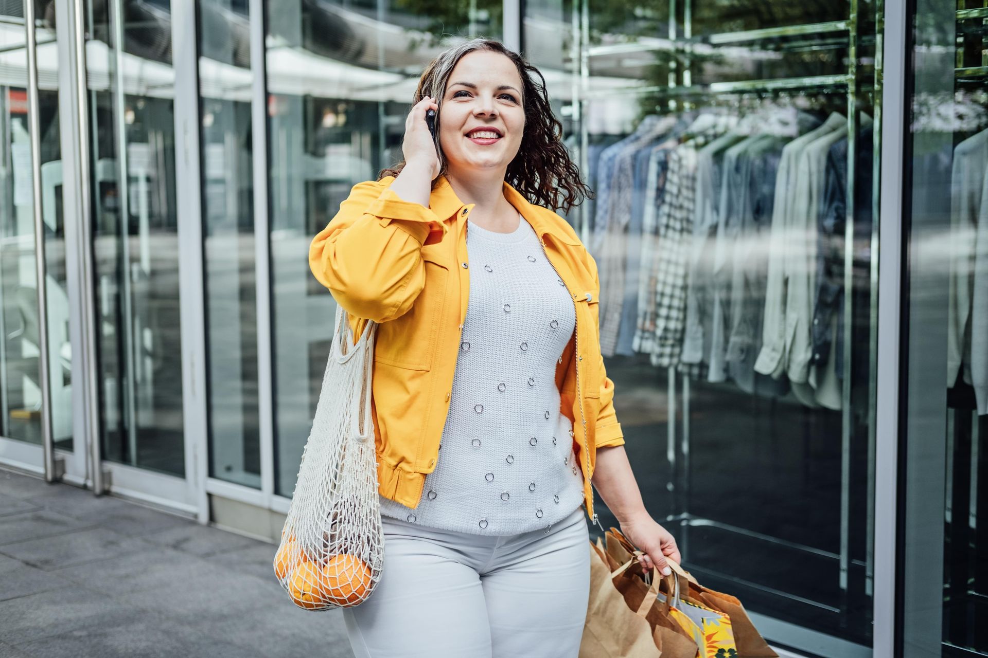 A person with a towel wrapped around their head is applying makeup.