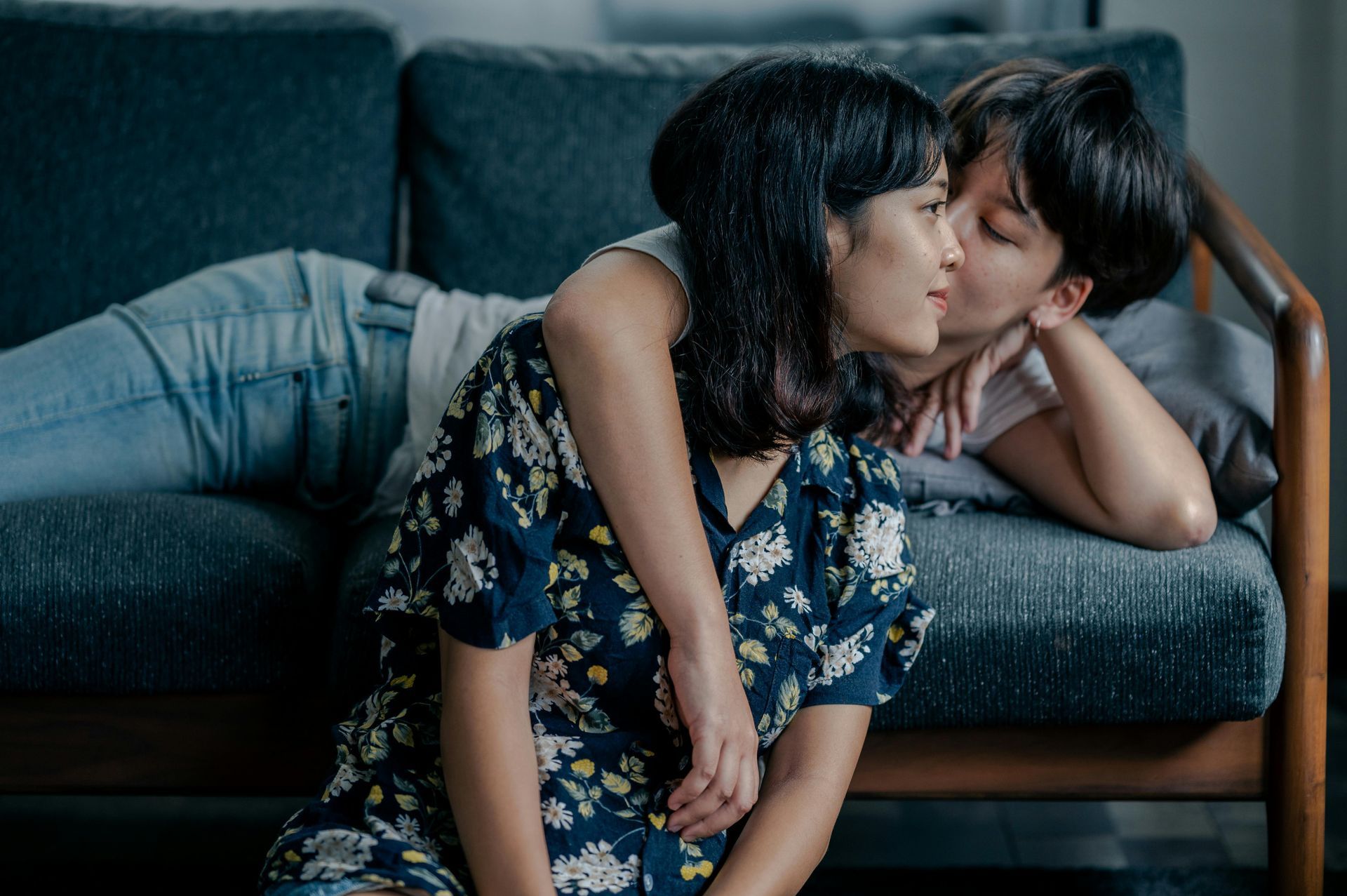 A person with a towel wrapped around their head is applying makeup.