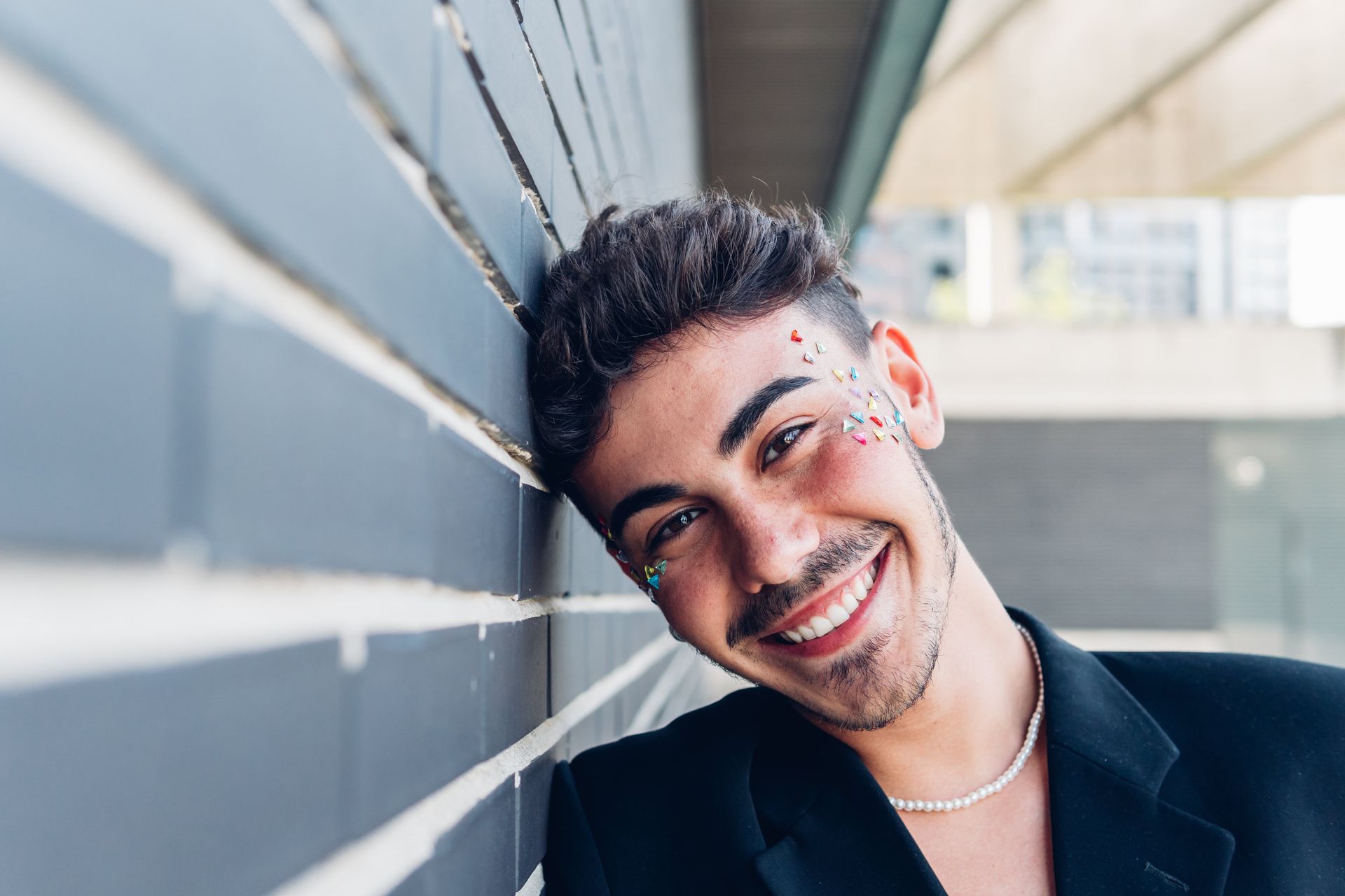 A person wearing a leopard print dress and a necklace.