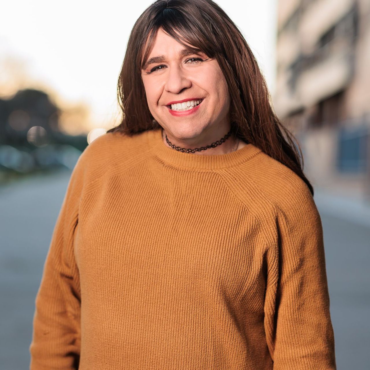 A person wearing a leopard print dress and a necklace.