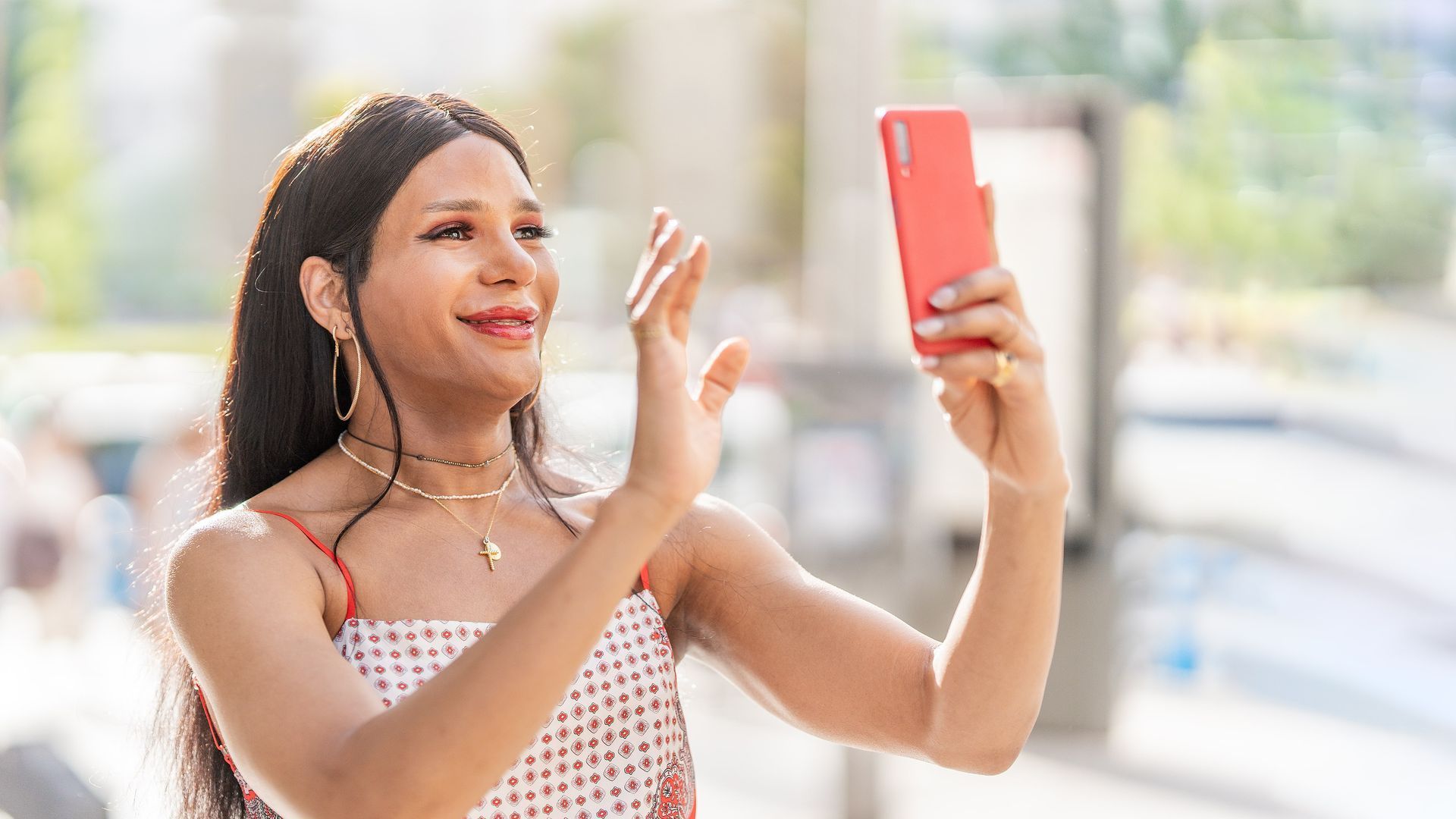 A person with a towel wrapped around their head is applying makeup.