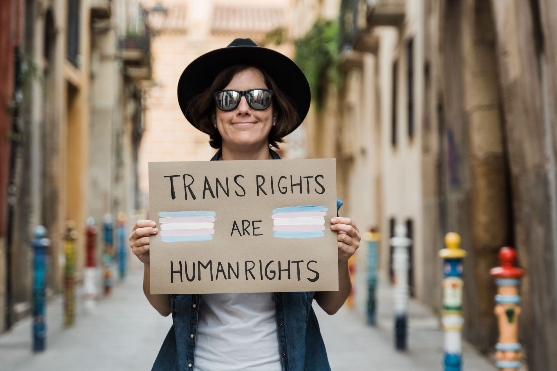 A person is holding a sign that says `` trans rights are human rights ''.