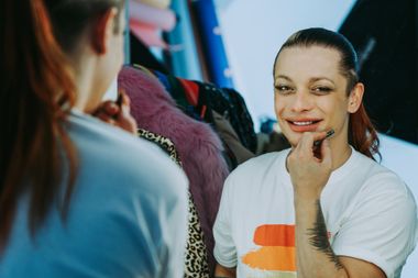 A person is looking at themselves in the mirror and smiling.