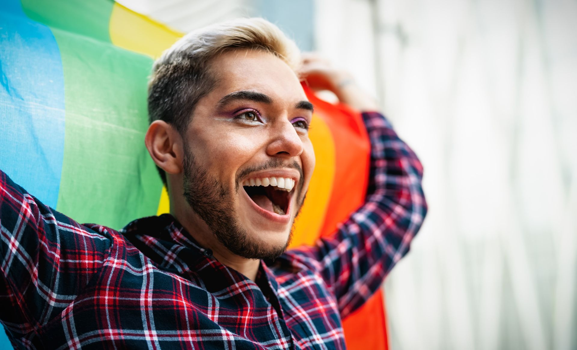 A person with a towel wrapped around their head is applying makeup.