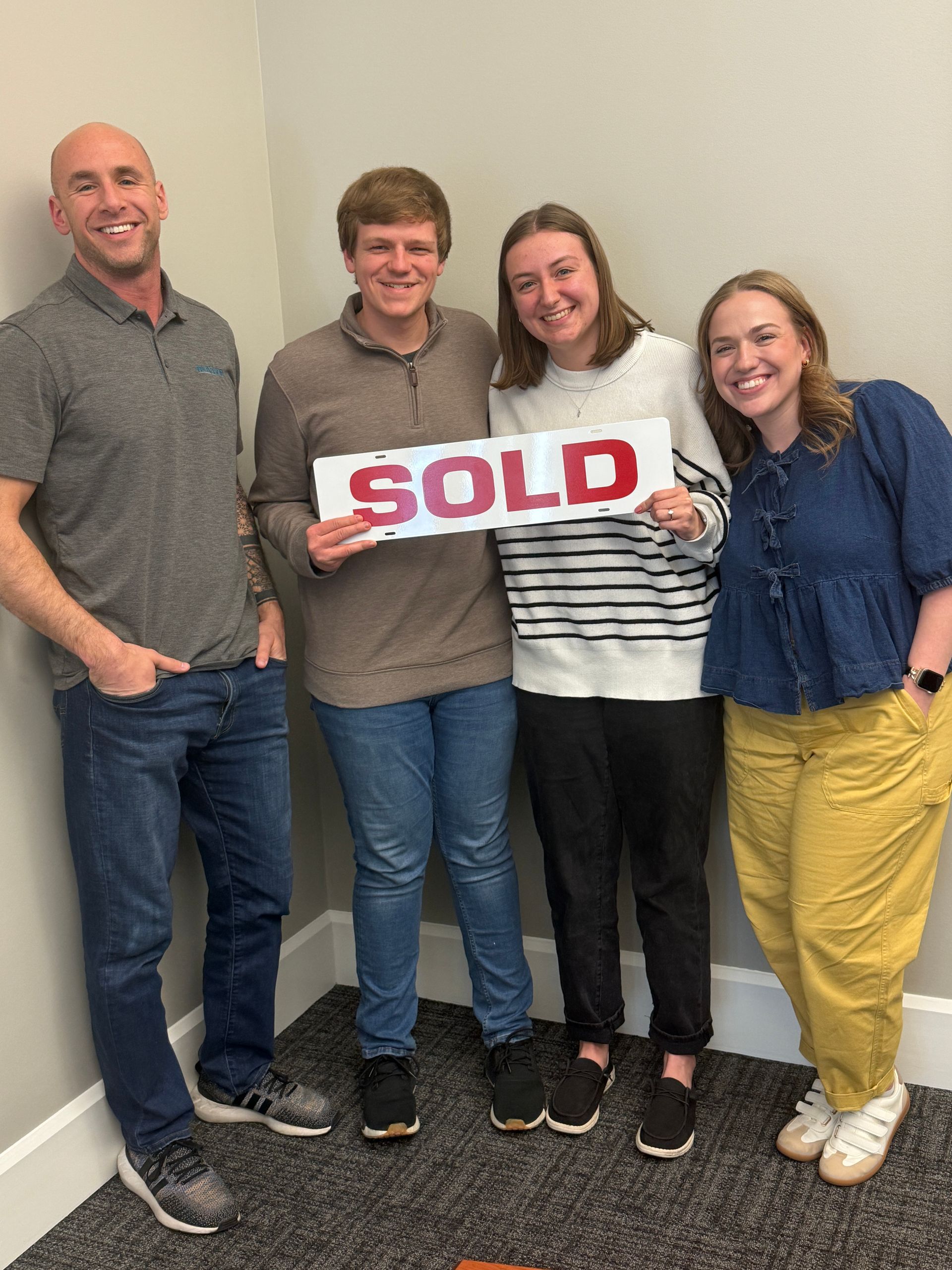 Group of four people holding a 