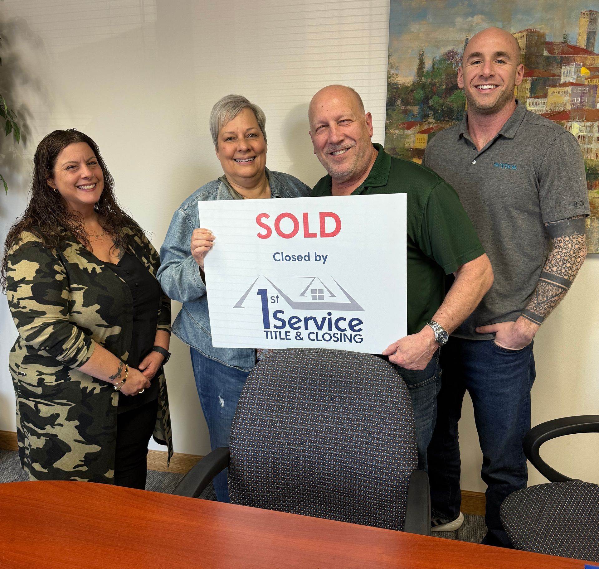 Four people holding a 