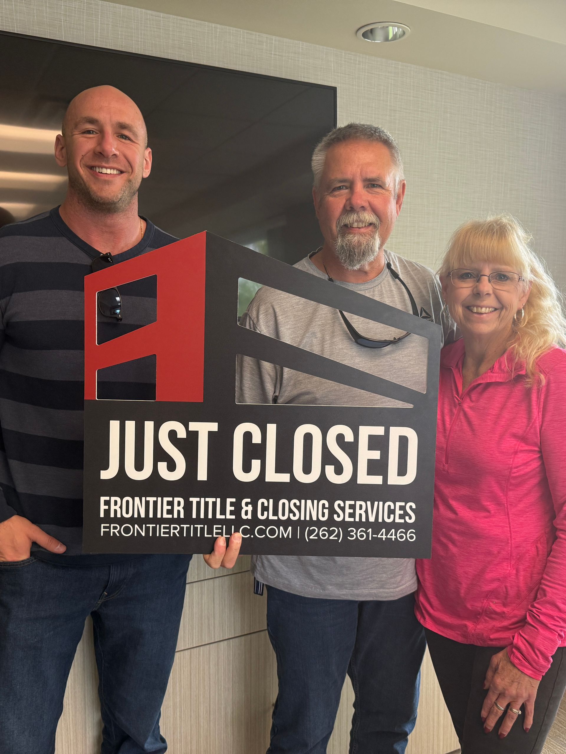 Three people holding a 