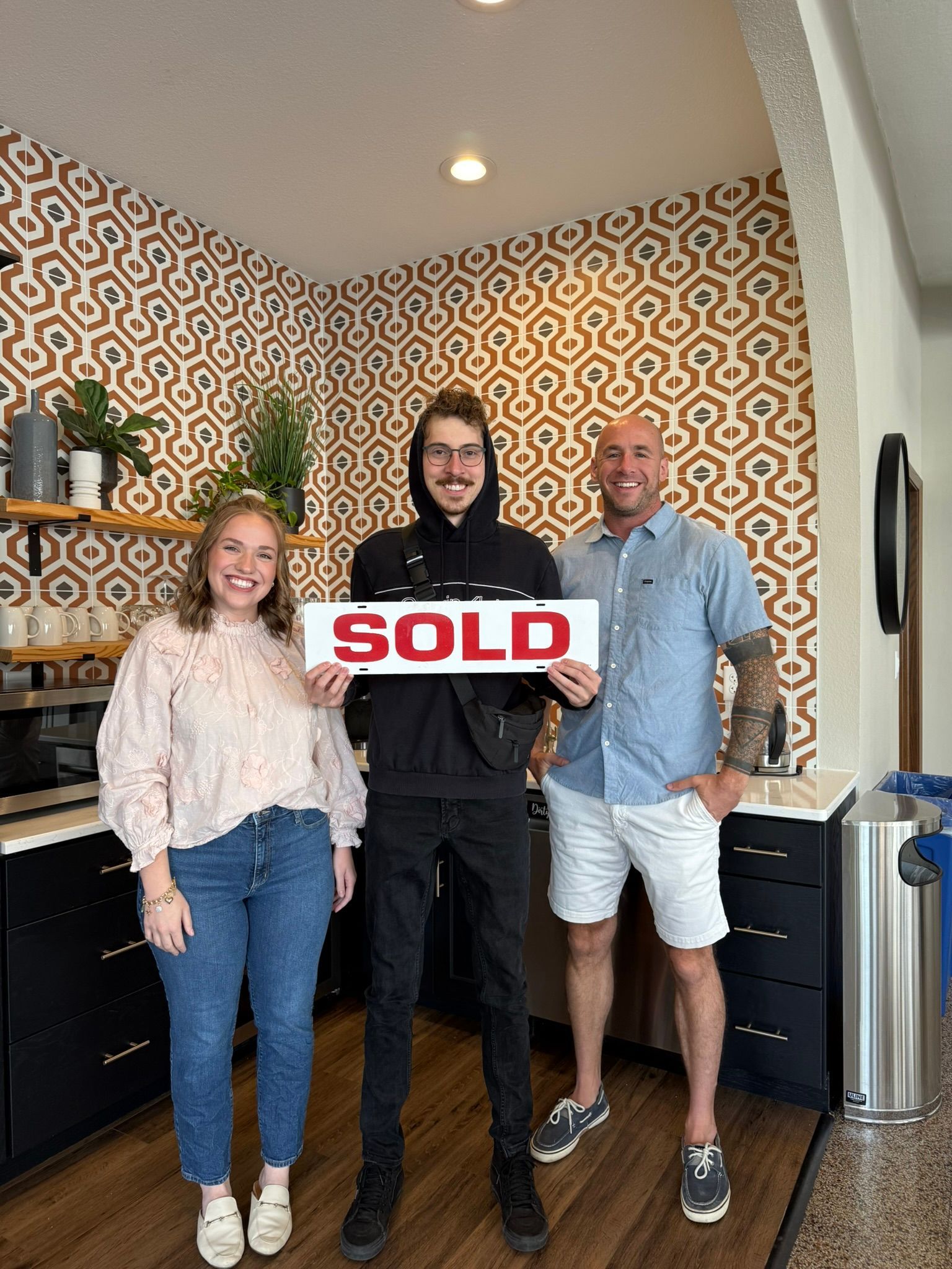 Three people holding 