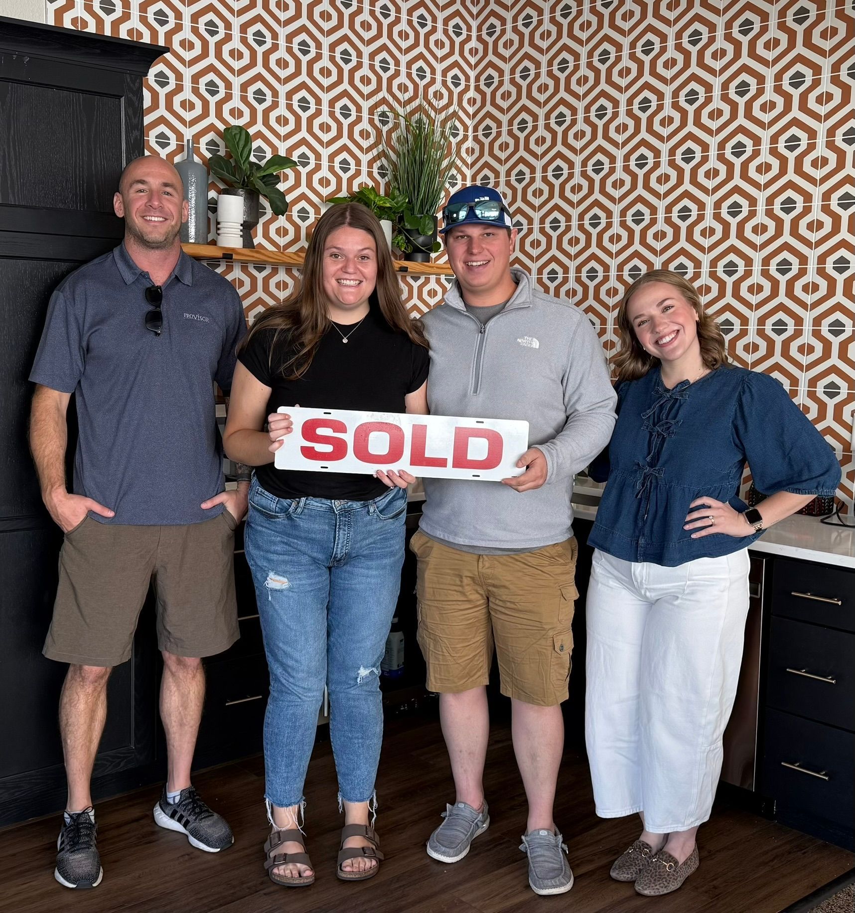 Four people holding a 