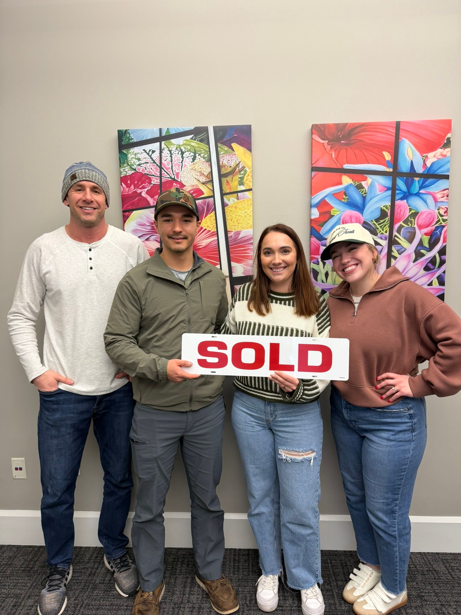 Four people holding a 