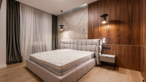 There is a bed with a mattress in the middle of the room.