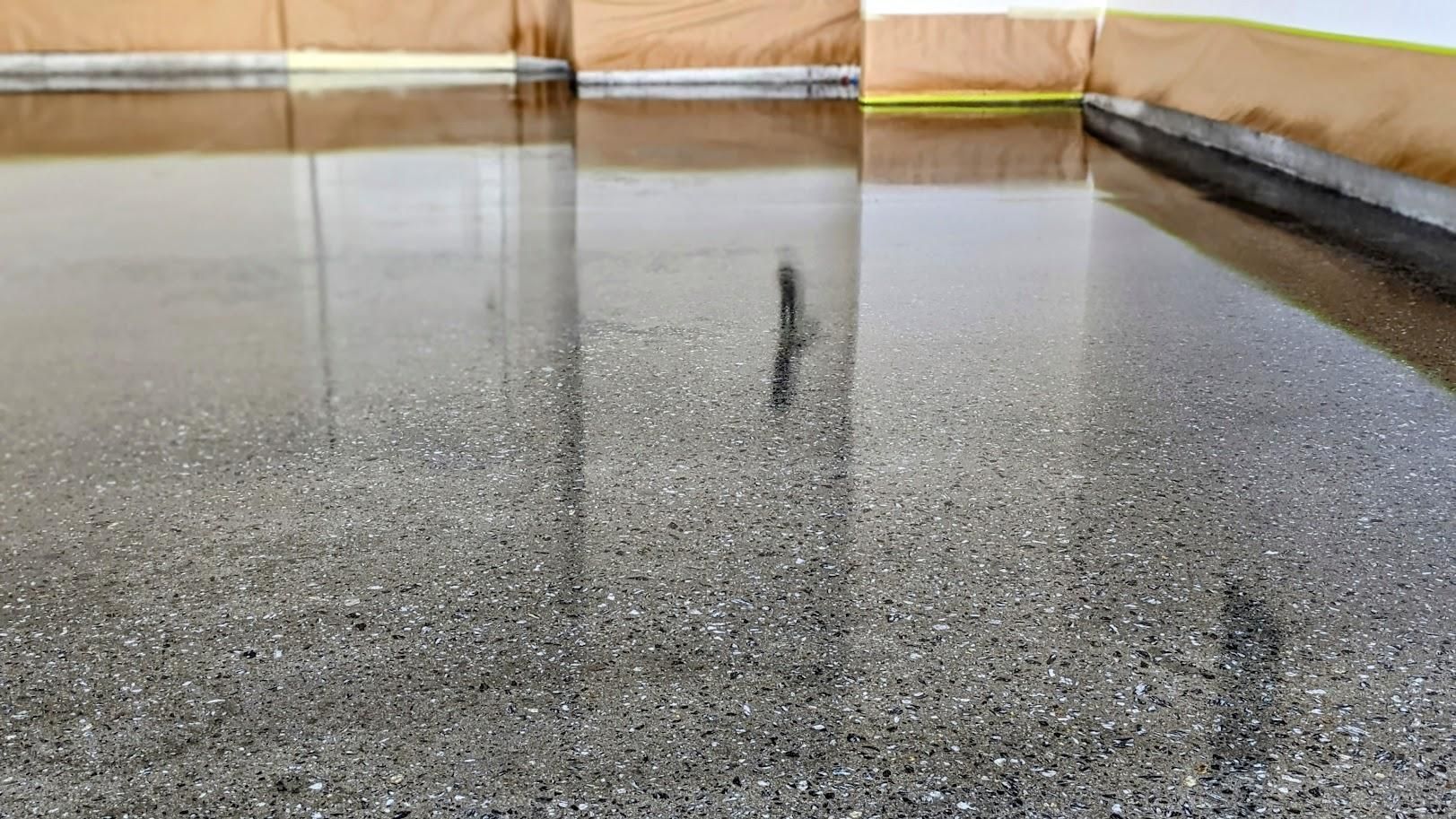 A close up of a shiny concrete floor in a garage.