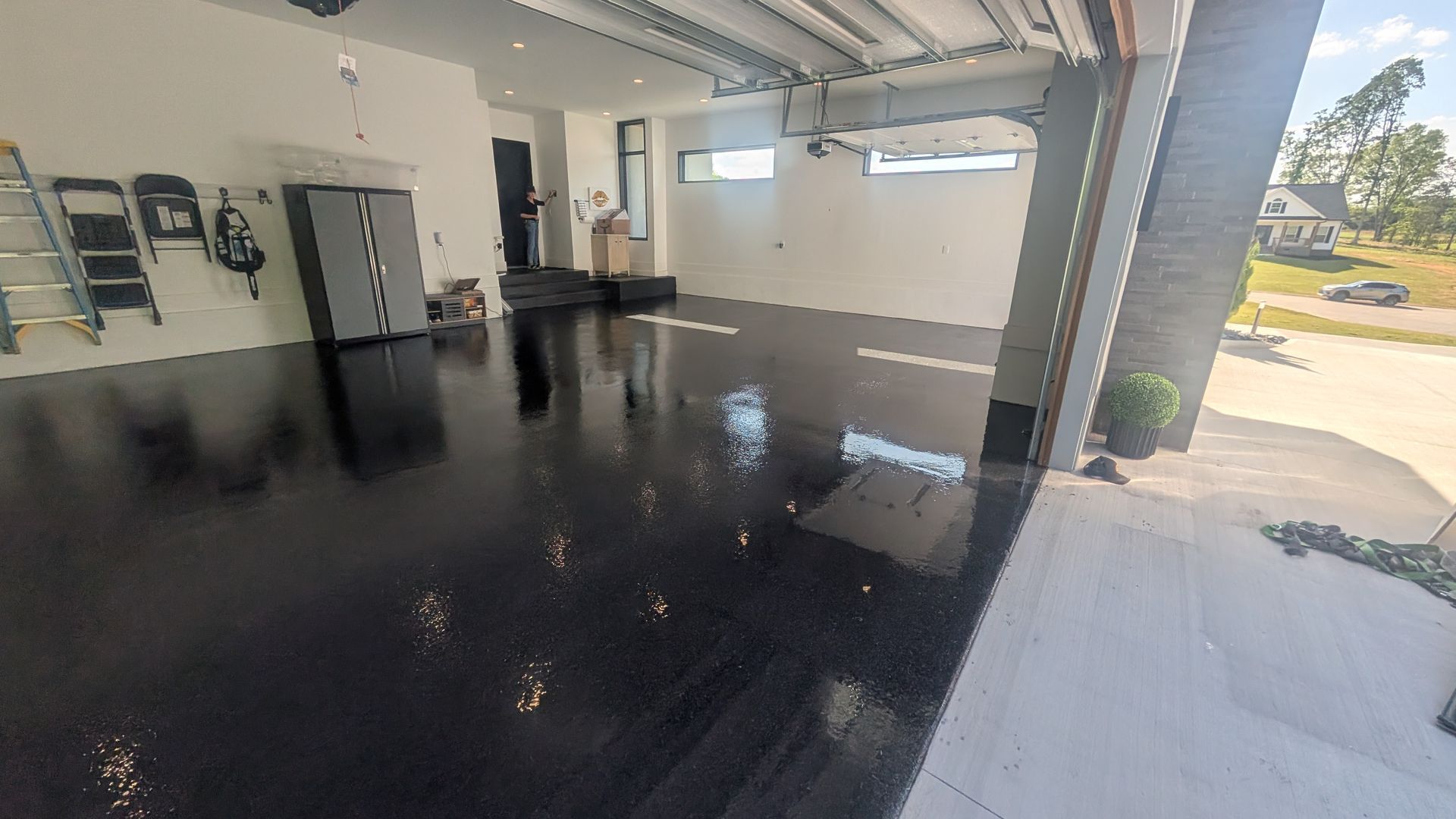 Wide view of glossy black garage flake floor installed by Zachary Daniel Concrete in Cross Hill, SC.