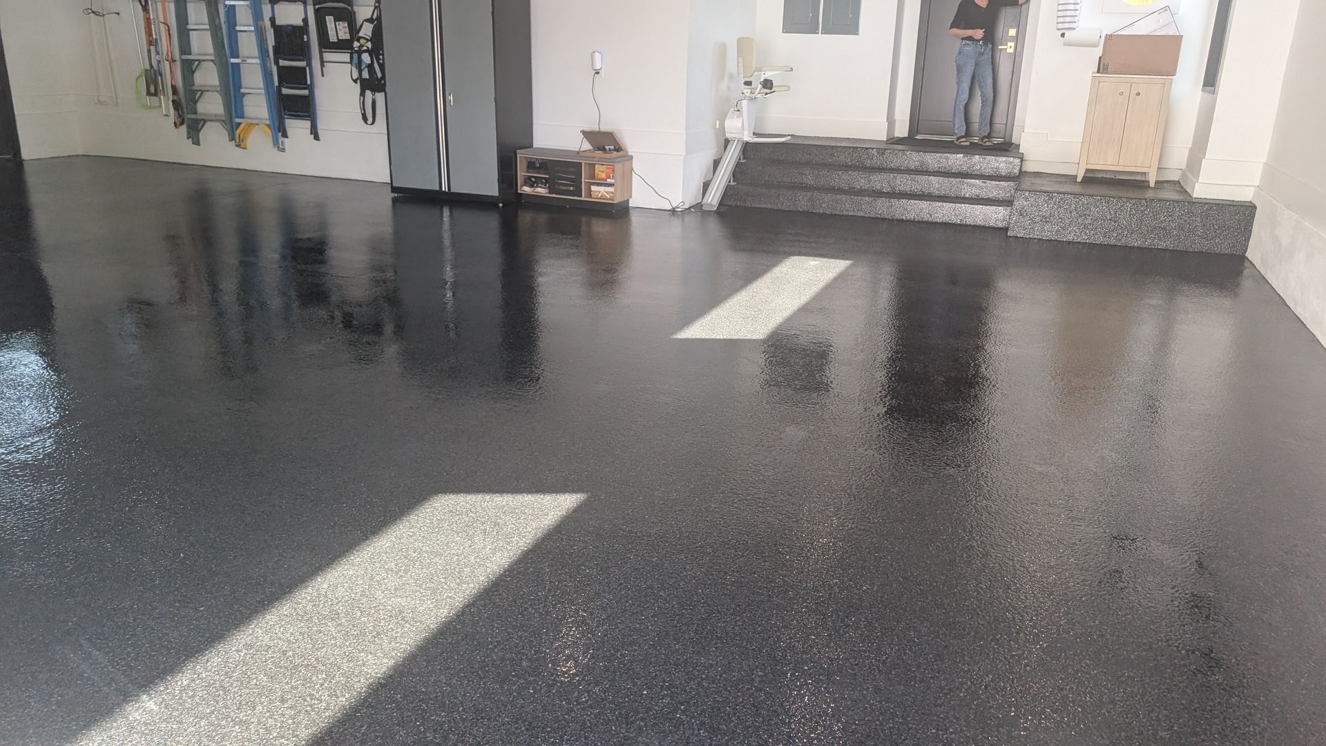 Mirror-like black epoxy flooring in garage space installed by Zachary Daniel Concrete in Hickory Tavern, SC.