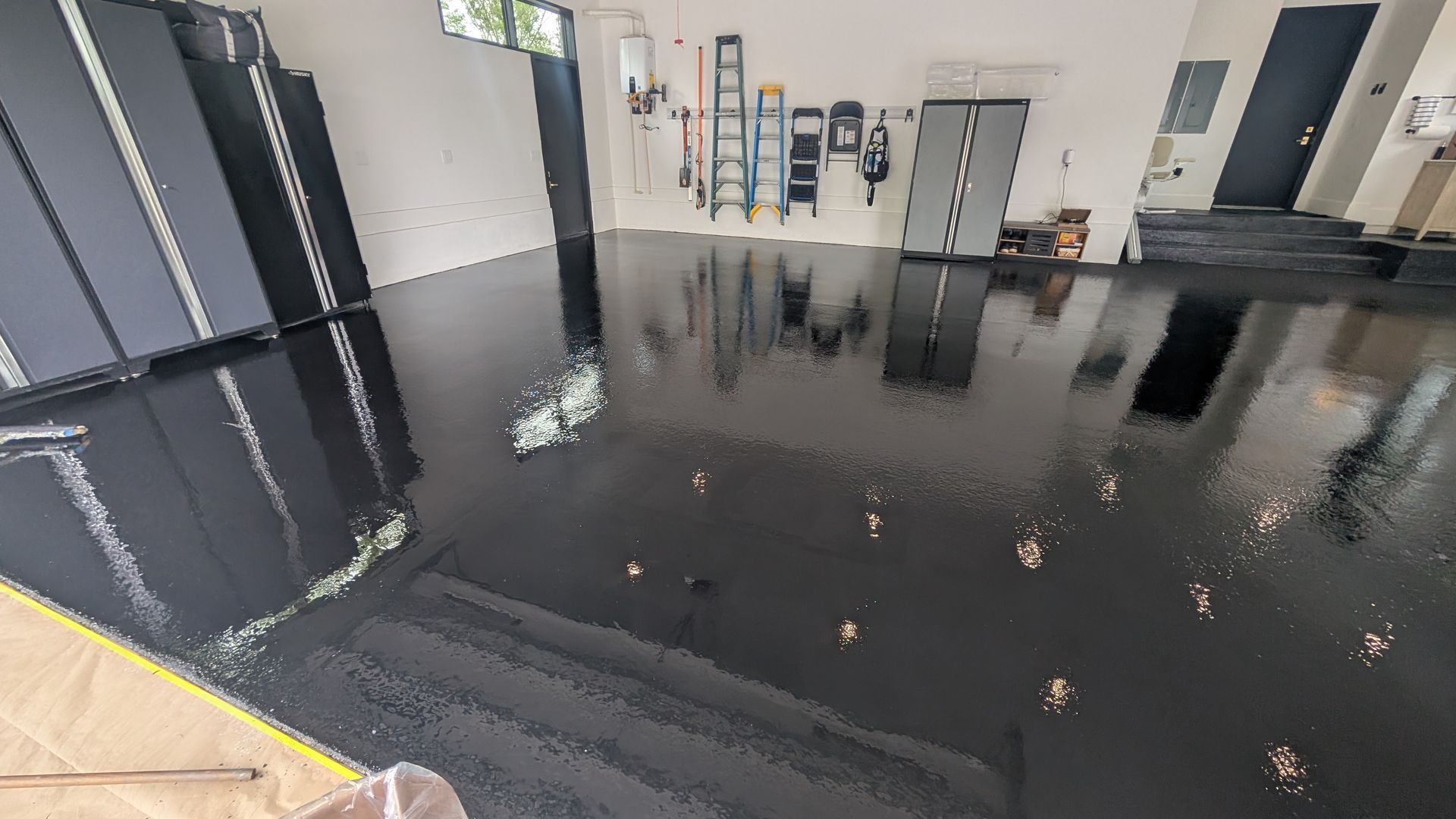 Glossy black epoxy flake garage floor finish installed by Zachary Daniel Concrete in Gray Court, SC.