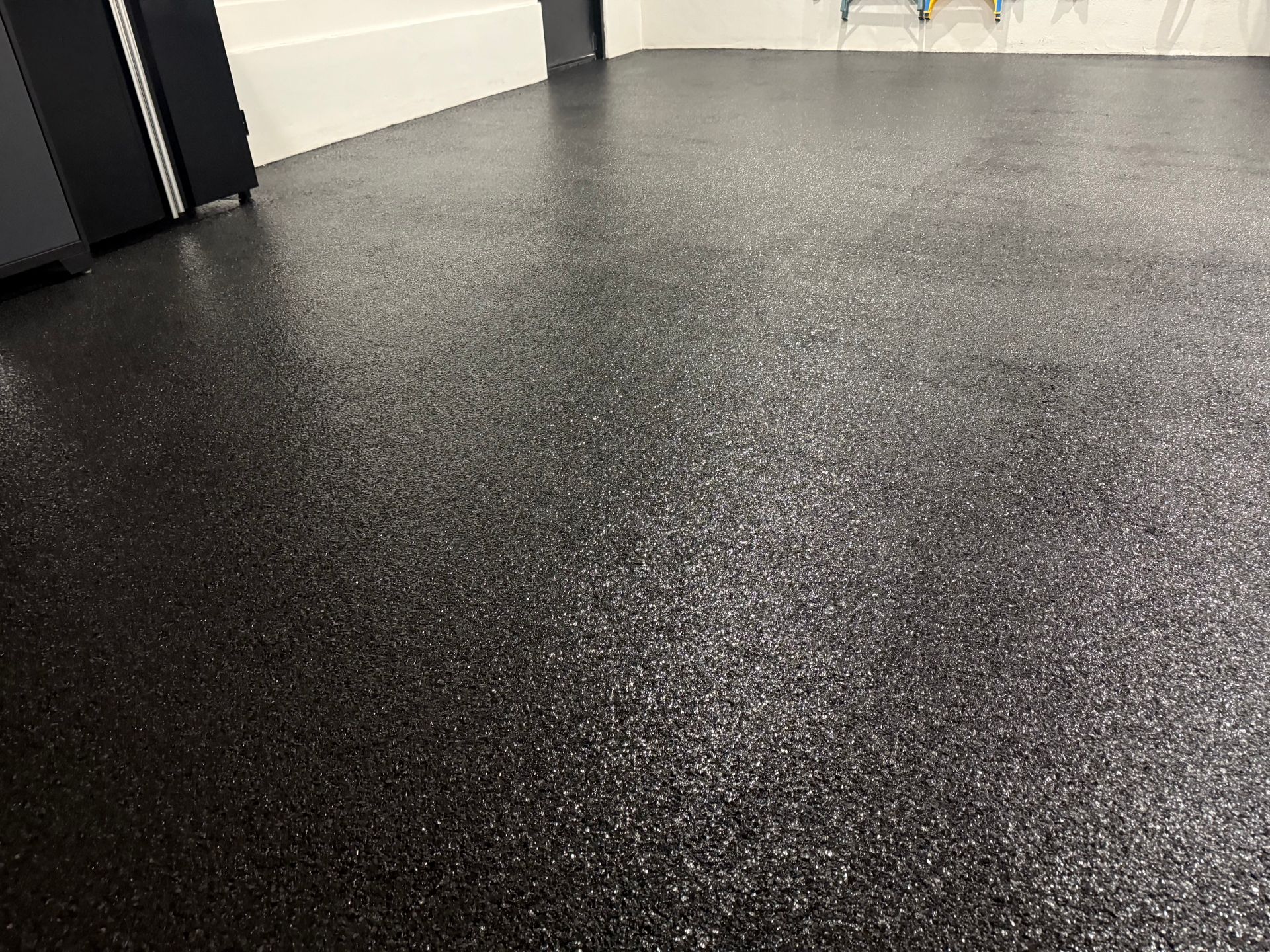 Full black epoxy flake finish with textured detail installed by Zachary Daniel Concrete in Whitmire, SC.