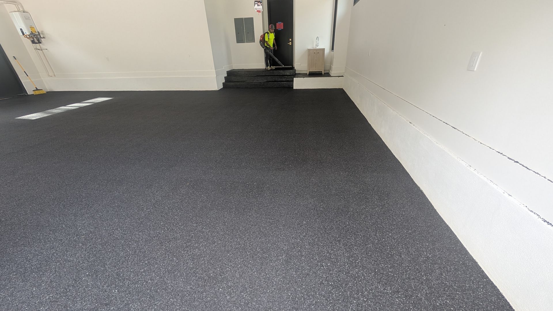 Matte black flake epoxy finish on enclosed garage floor installed by Zachary Daniel Concrete in Cross Anchor, SC.