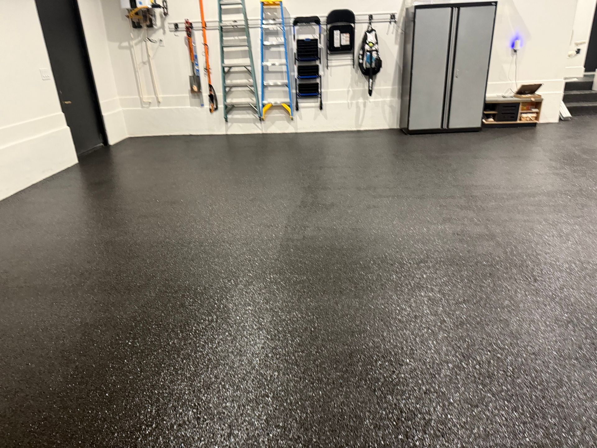 Polished epoxy flake garage floor with seamless finish installed by Zachary Daniel Concrete in Enoree, SC.