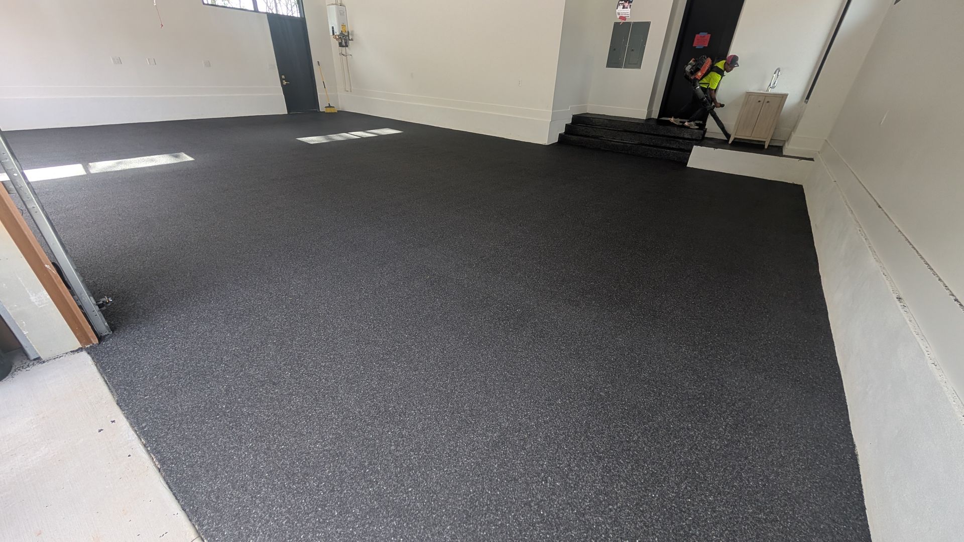 Epoxy flake garage floor with dark textured coating installed by Zachary Daniel Concrete in Laurens, SC.