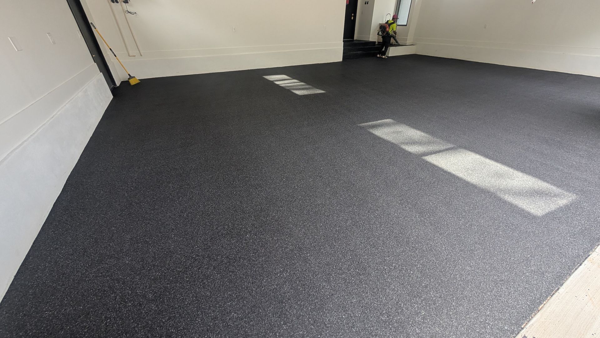 Epoxy garage floor with flake finish and daylight reflection installed by Zachary Daniel Concrete in Ninety Six, SC.