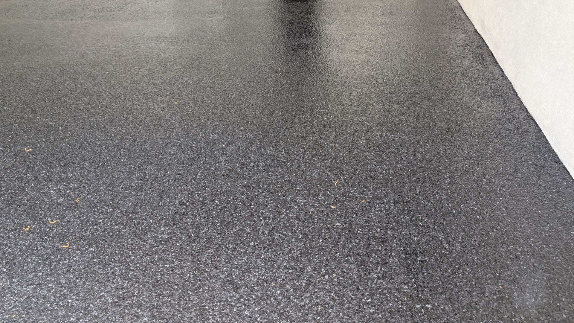 Close-up of epoxy flake garage floor with fine texture installed by Zachary Daniel Concrete in Donalds, SC.