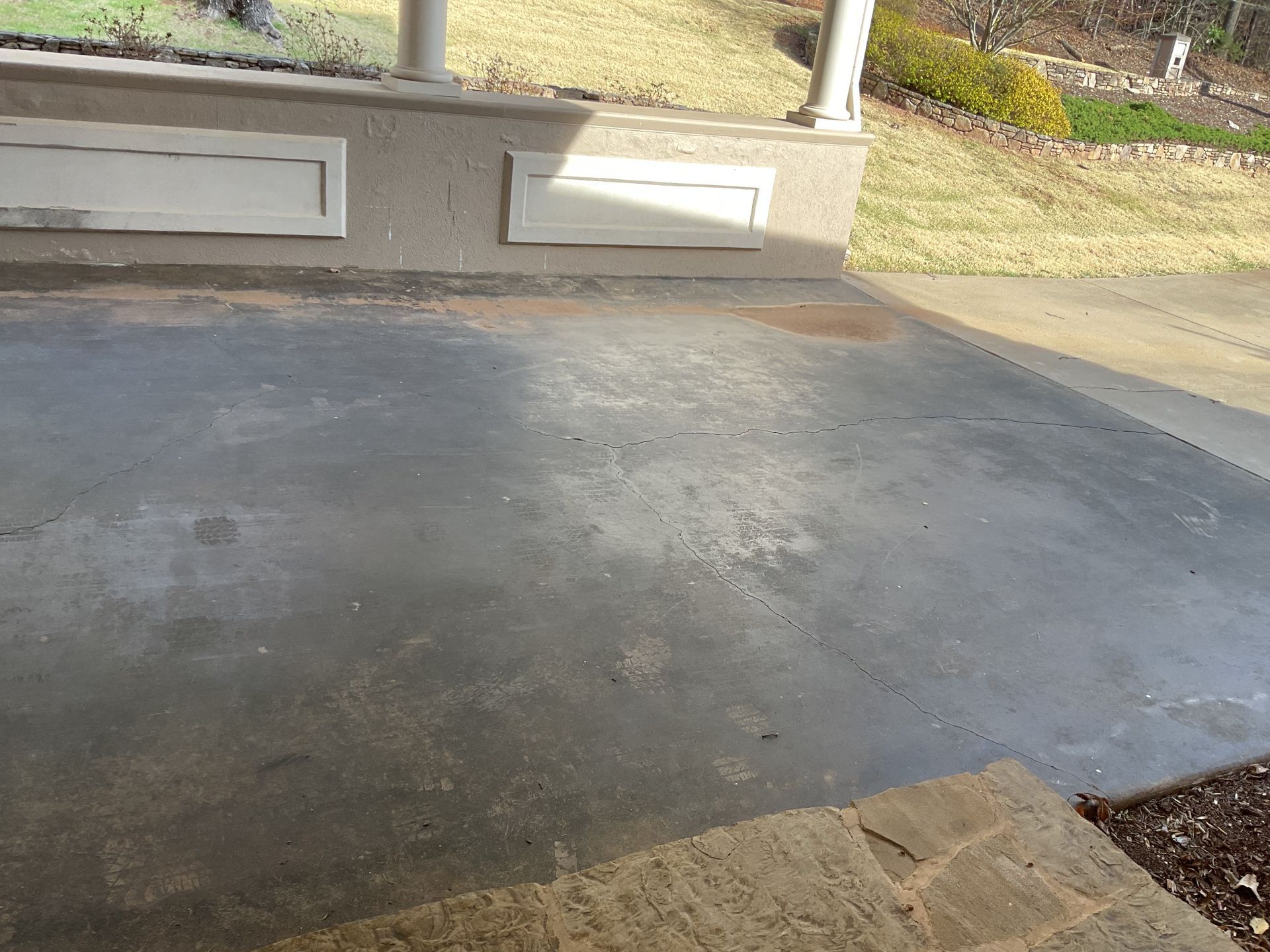 Grind and seal finish beside residential wall installed by Zachary Daniel Concrete in Gantt, SC.