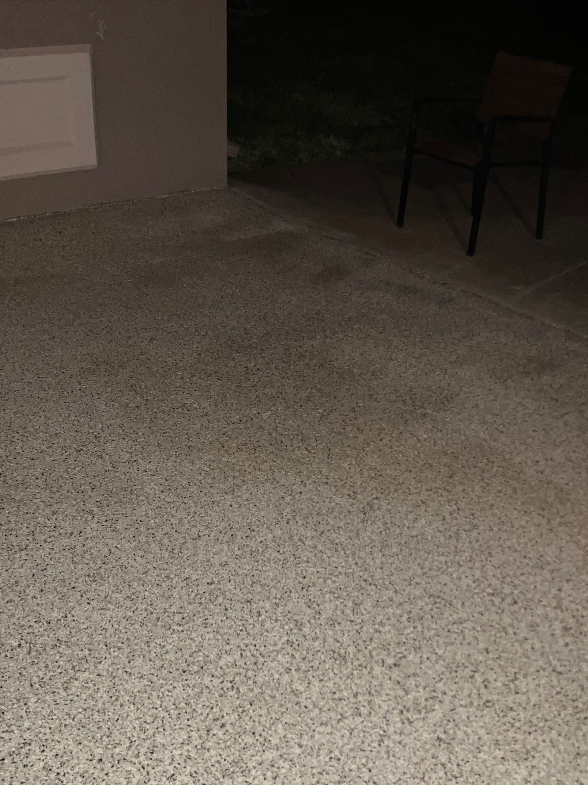 Textured epoxy flake surface under shaded space installed by Zachary Daniel Concrete in Henrietta, NC.